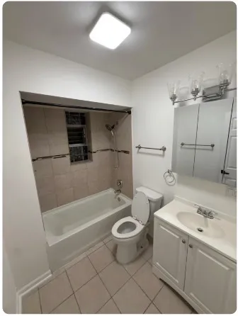 a bathroom with a bathtub toilet and a sink