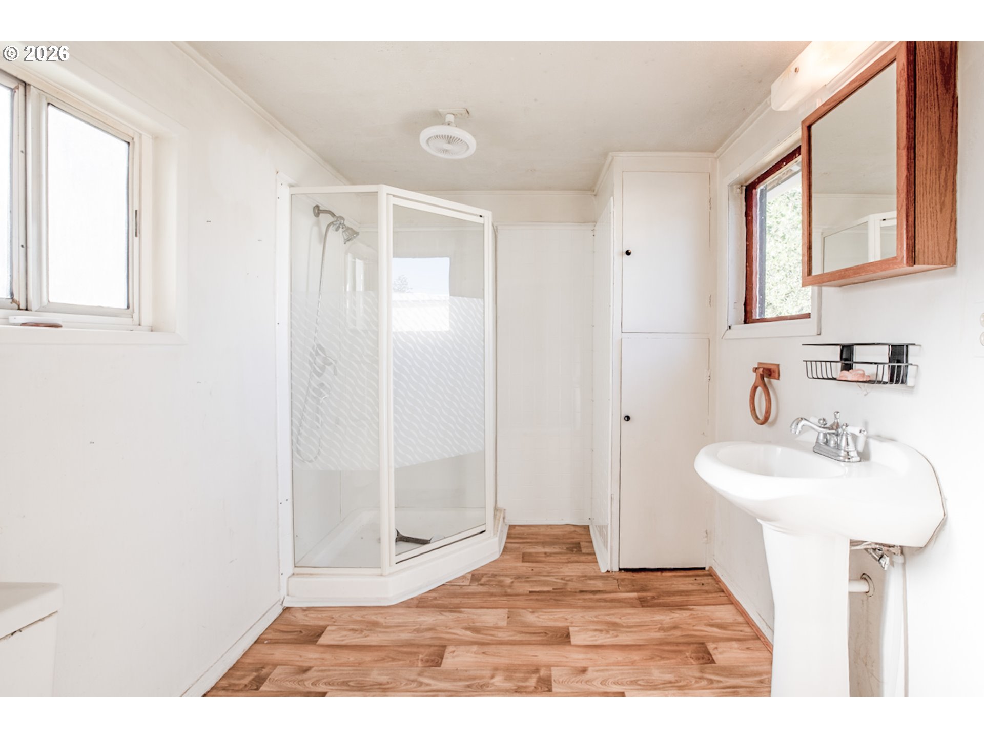 47433 School Street Oakridge, OR 97463 - Photo 7 of 16 a bathroom with a sink a mirror and shower