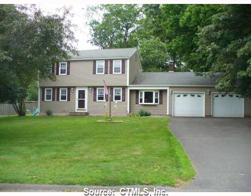 a view of a yard in front of a house with large tree