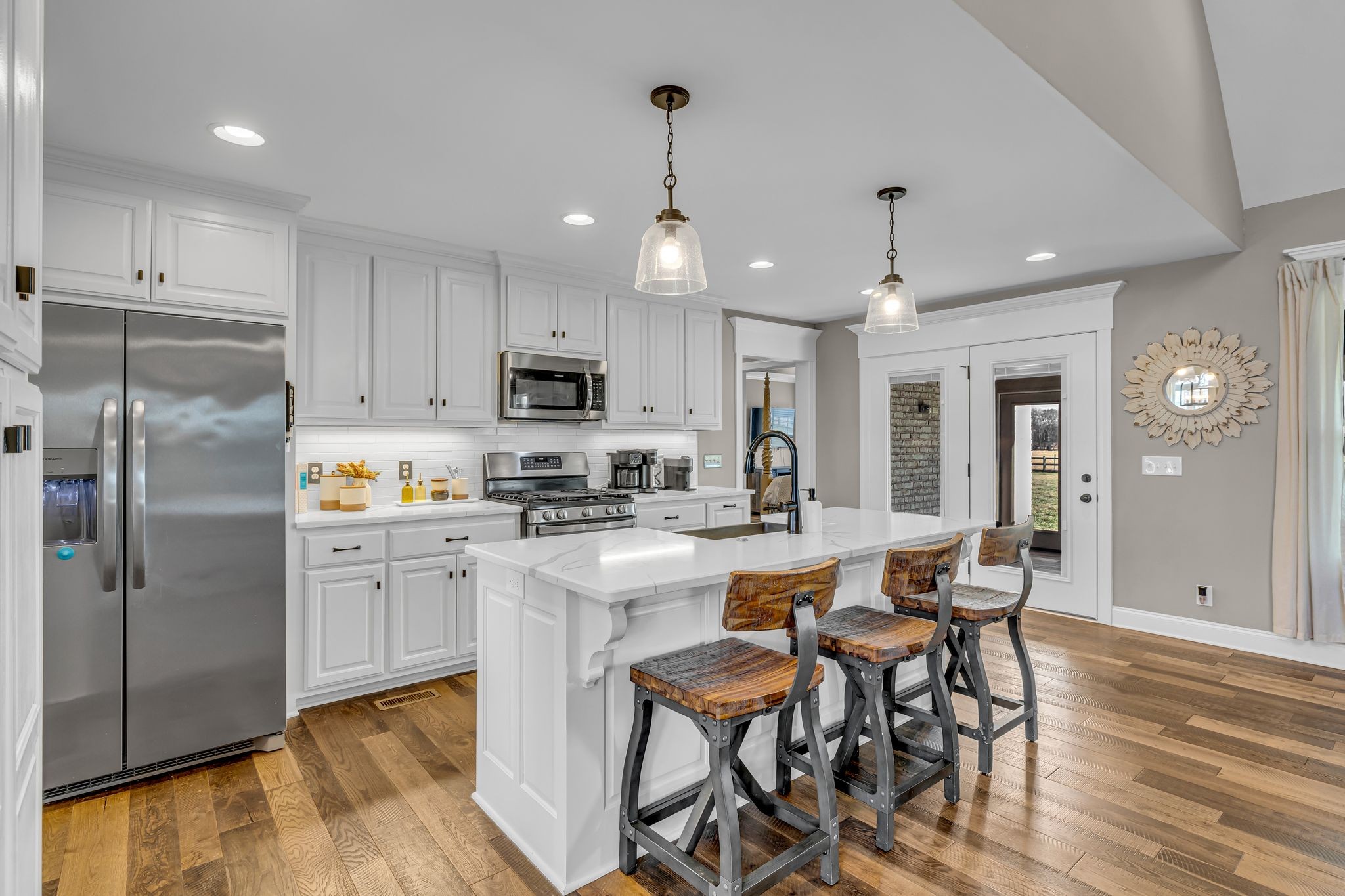 852 Longview Road Shelbyville, TN 37160 - Photo 14 of 38 a kitchen with stainless steel appliances granite countertop a refrigerator a stove top oven a sink dishwasher and white cabinets with wooden floor