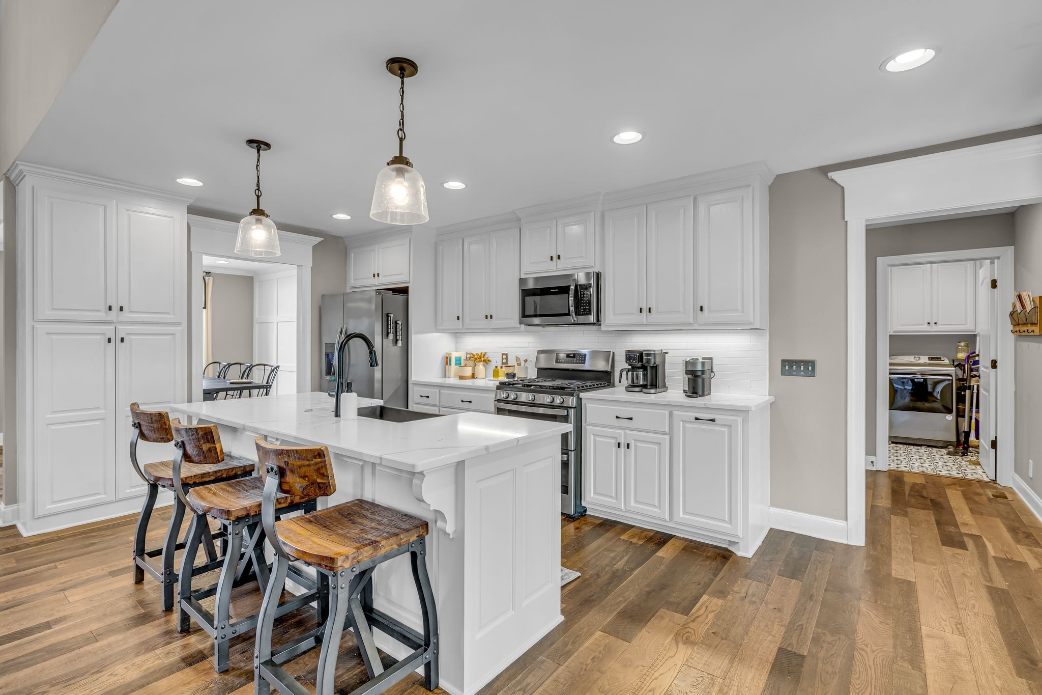852 Longview Road Shelbyville, TN 37160 - Photo 15 of 38 a kitchen with white cabinets stainless steel appliances and dining table