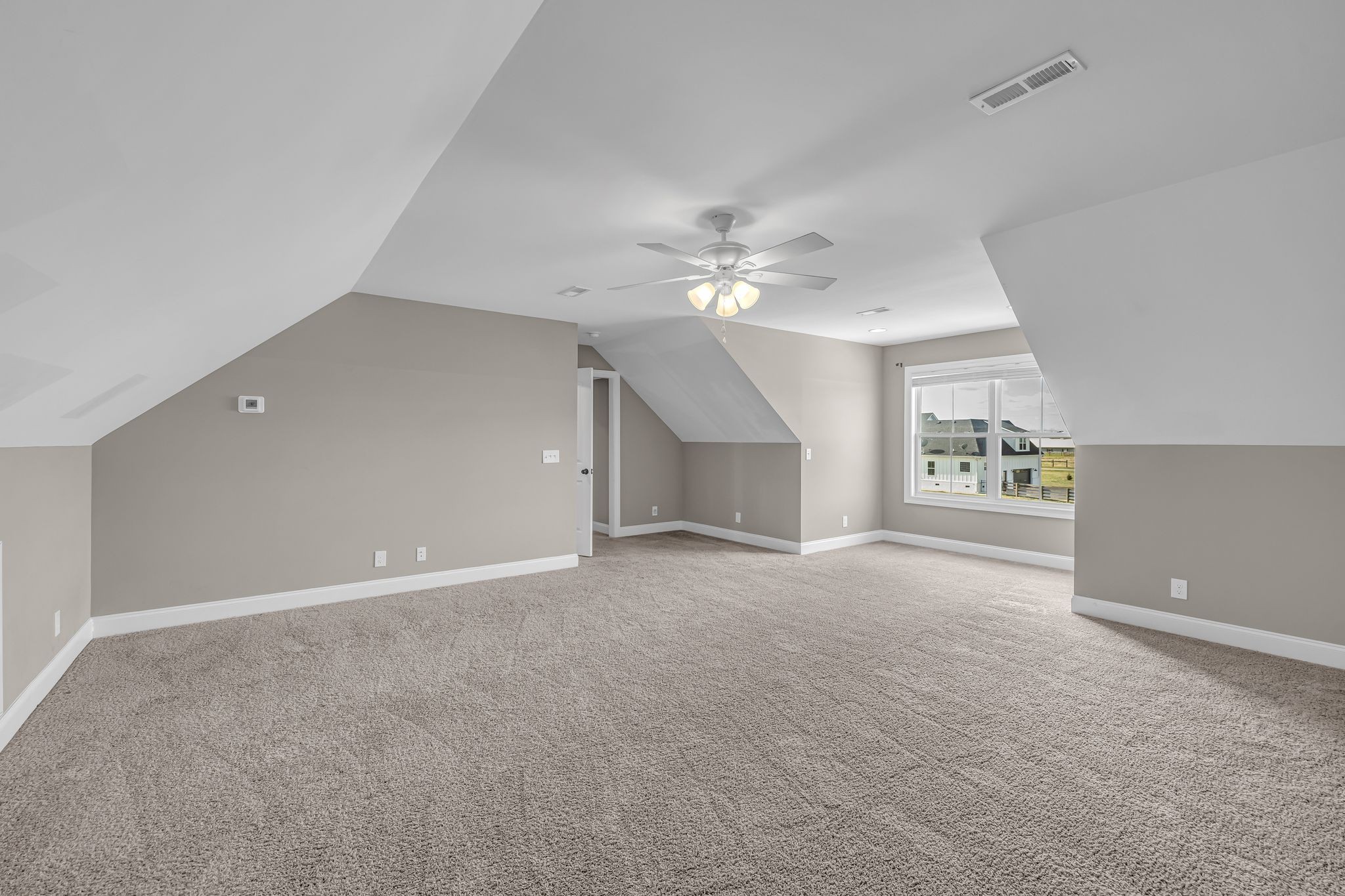 852 Longview Road Shelbyville, TN 37160 - Photo 31 of 38 en empty room with windows and chandelier fan