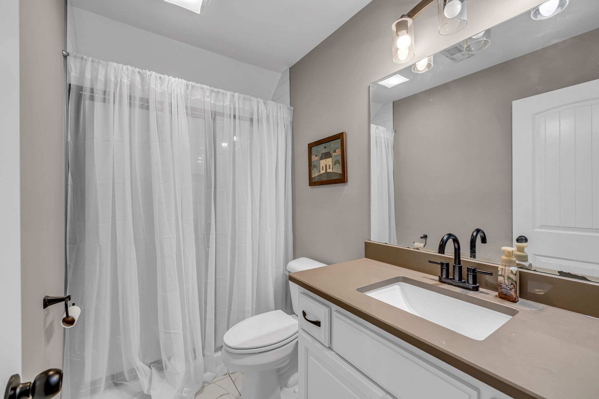 852 Longview Road Shelbyville, TN 37160 - Photo 32 of 38 a bathroom with a sink a toilet a mirror and shower curtain