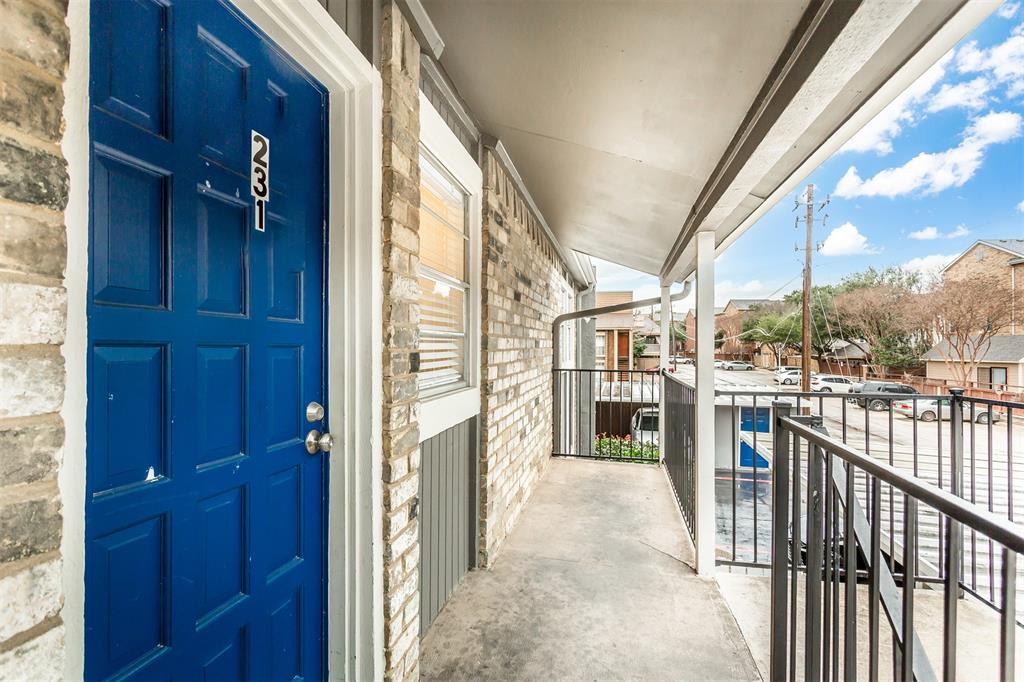 6061 Milton Street, Unit 231 Dallas, TX 75206 - Photo 26 of 27 Welcoming second-floor entry with a covered front balcony, offering a private elevated approach and space to enjoy morning coffee or unwind outdoors