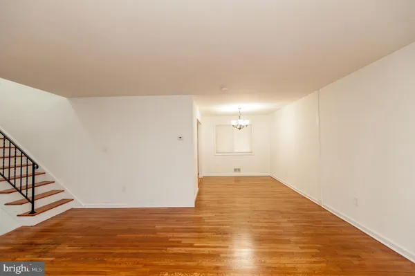 a view of a kitchen with wooden floor and staircase