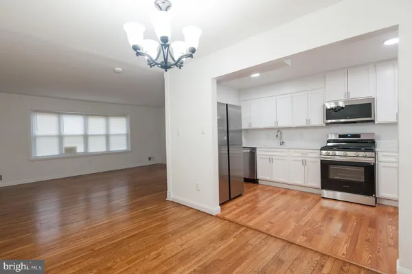 a stove top oven sitting inside of a kitchen