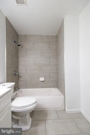 a bathroom with a sink toilet and a mirror