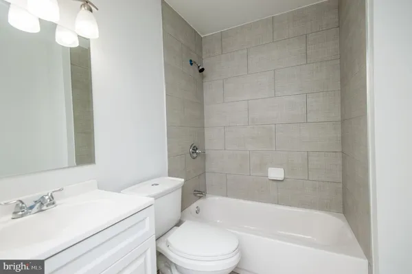 a bathroom with a toilet and a bath tub