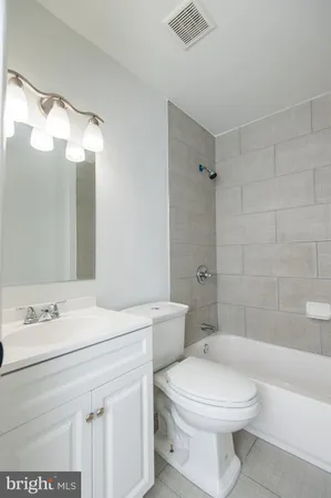 a bathroom with a toilet a sink and bathtub