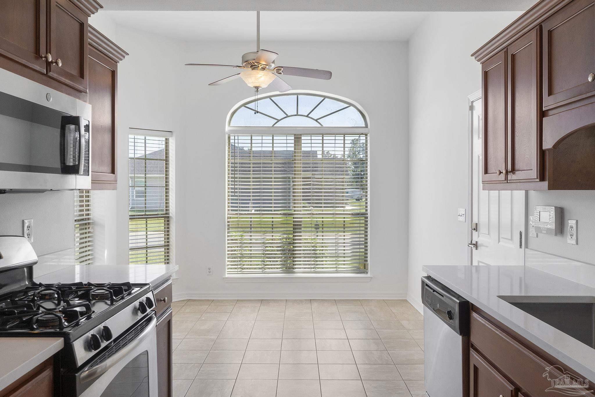 576 Edith Lane Pensacola, FL 32534 - Photo 11 of 38 a kitchen with stainless steel appliances granite countertop a stove a sink and a granite counter tops