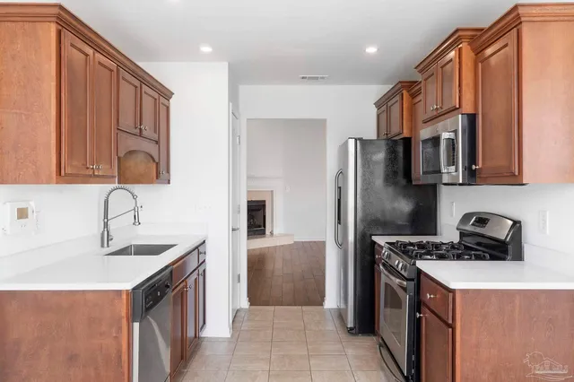 a kitchen with stainless steel appliances granite countertop a sink and a stove top oven