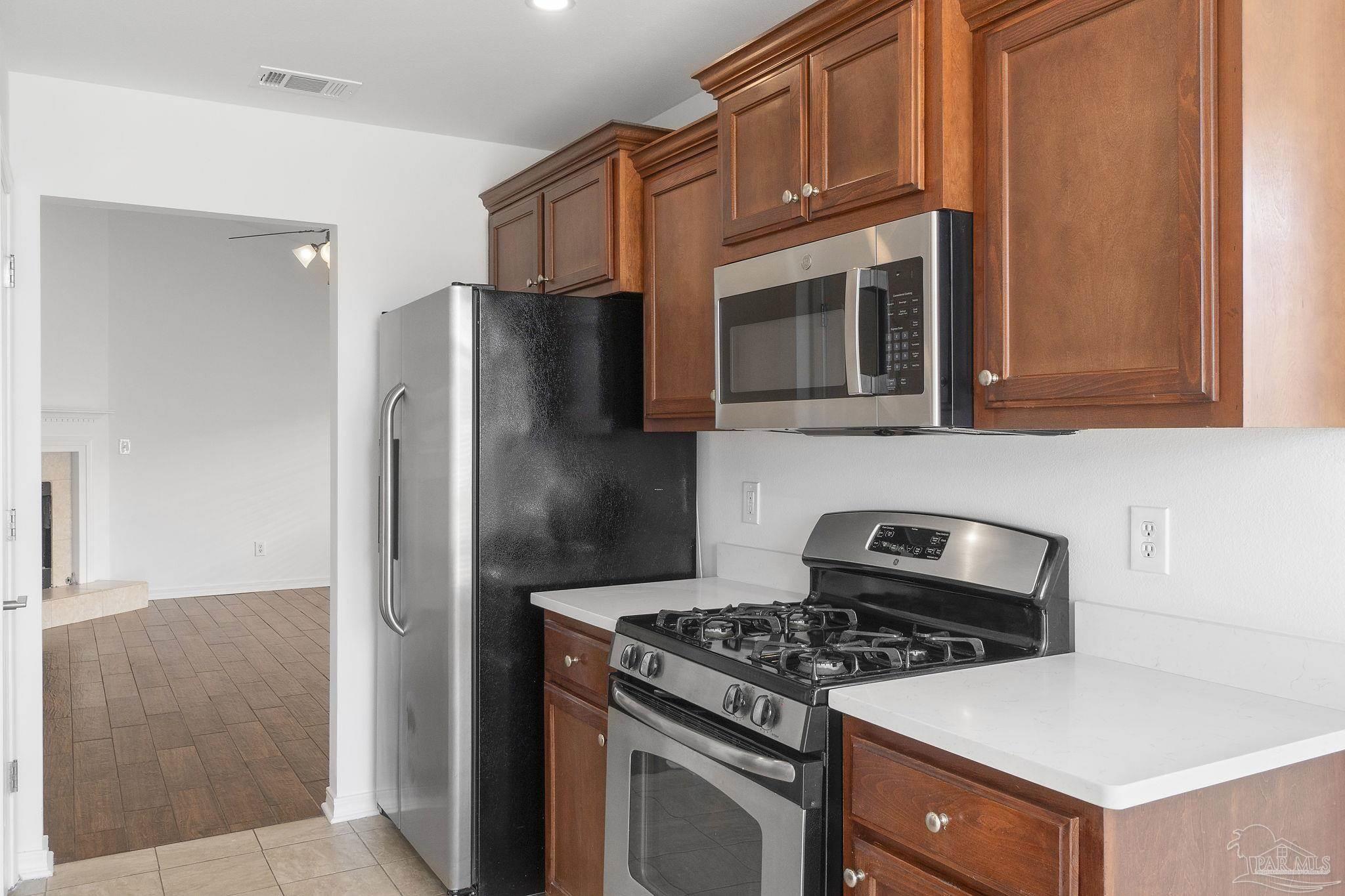 576 Edith Lane Pensacola, FL 32534 - Photo 14 of 38 a kitchen with stainless steel appliances granite countertop a stove and a refrigerator