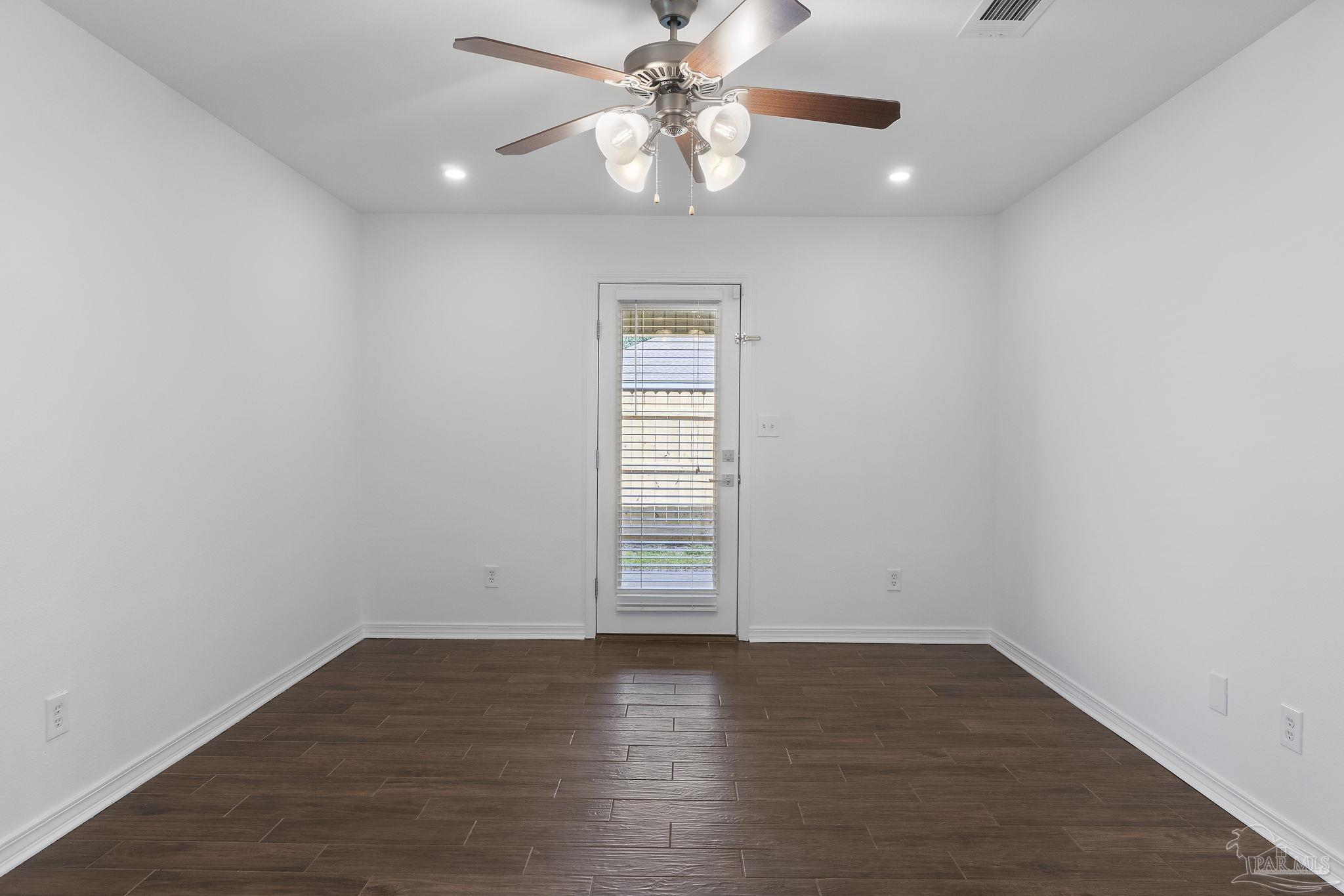 576 Edith Lane Pensacola, FL 32534 - Photo 21 of 38 an empty room with wooden floor chandelier fan and windows