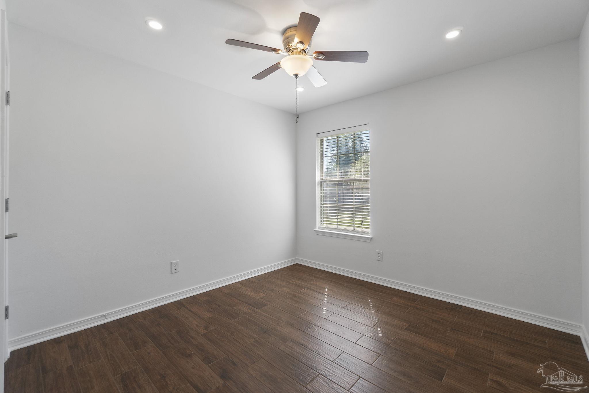 576 Edith Lane Pensacola, FL 32534 - Photo 26 of 38 wooden floor in an empty room with a window
