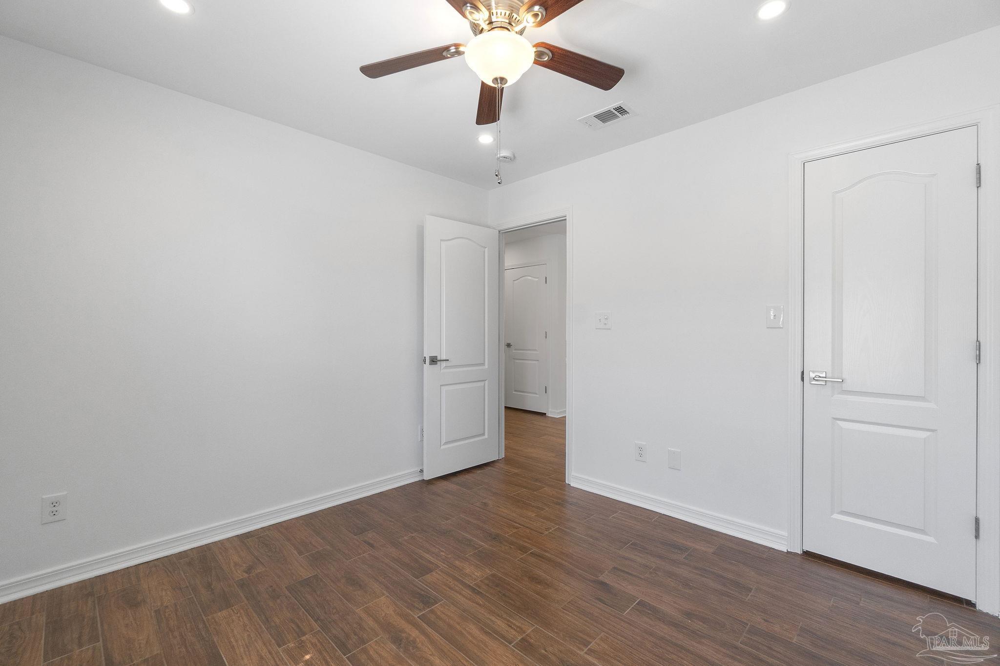 576 Edith Lane Pensacola, FL 32534 - Photo 27 of 38 a view of an empty room with wooden floor
