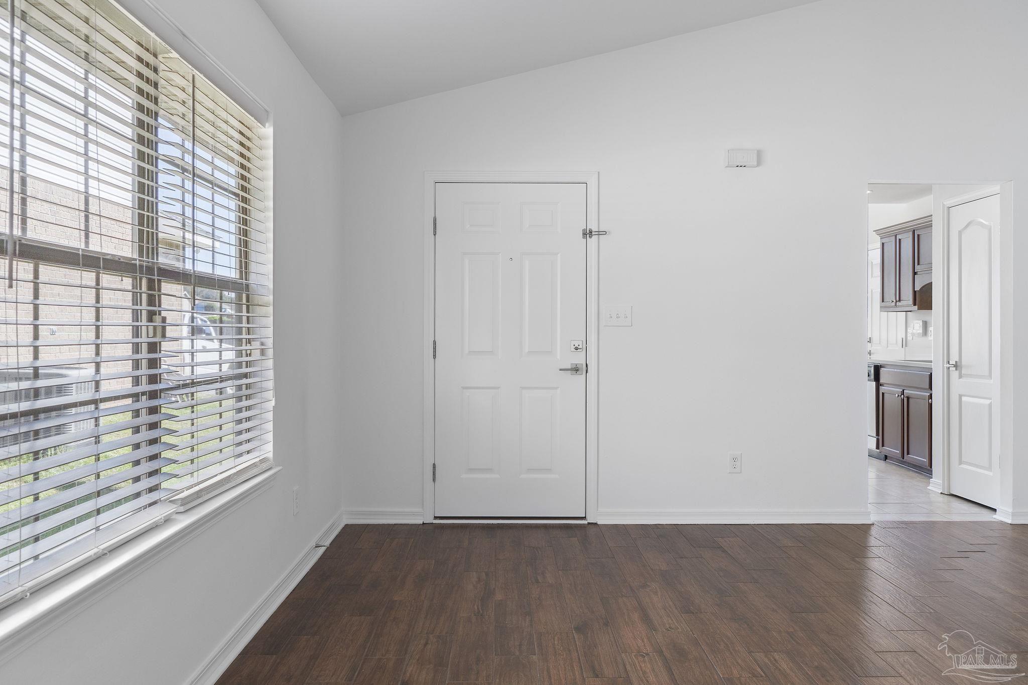 576 Edith Lane Pensacola, FL 32534 - Photo 6 of 38 a view of an empty room with wooden floor and a window