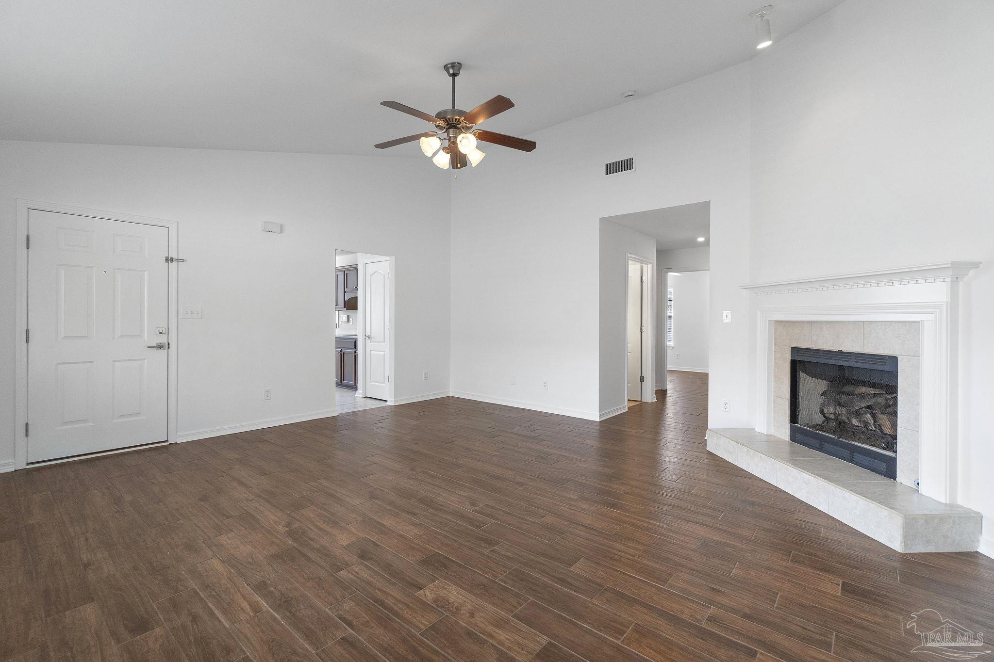 576 Edith Lane Pensacola, FL 32534 - Photo 8 of 38 a view of an empty room with wooden floor and fireplace