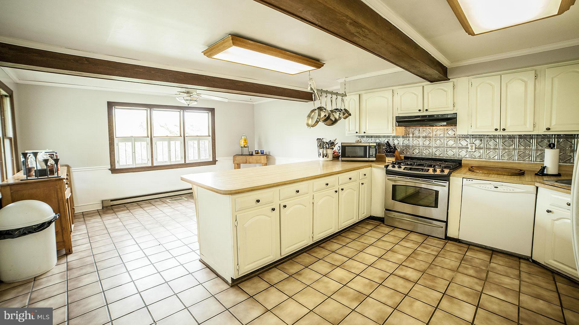 28901 Kemptown Road Mount Airy, MD 21771 - Photo 12 of 29 a kitchen with a stove sink and cabinets