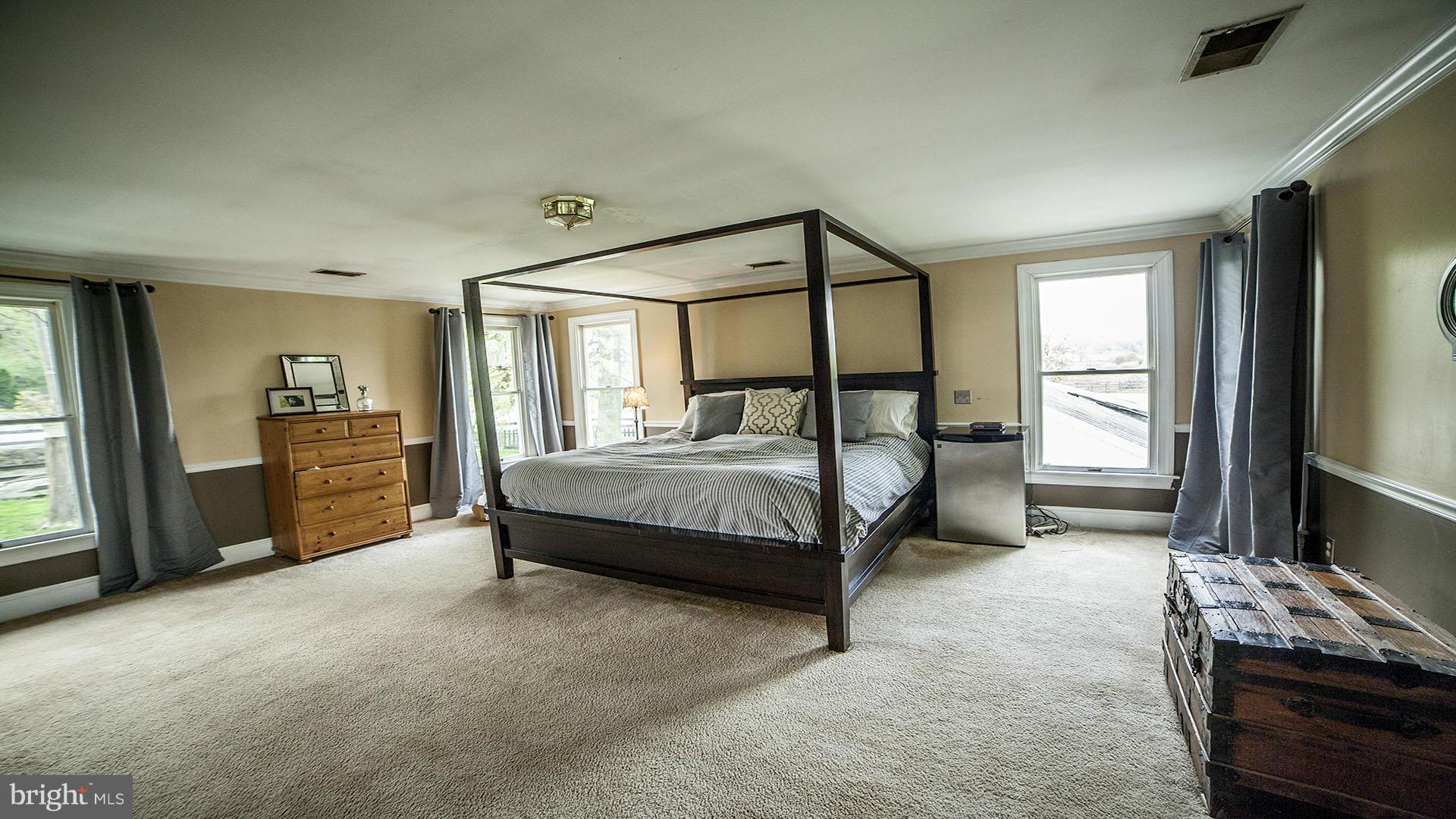 28901 Kemptown Road Mount Airy, MD 21771 - Photo 15 of 29 a bedroom with a bed table and a flat tv screen