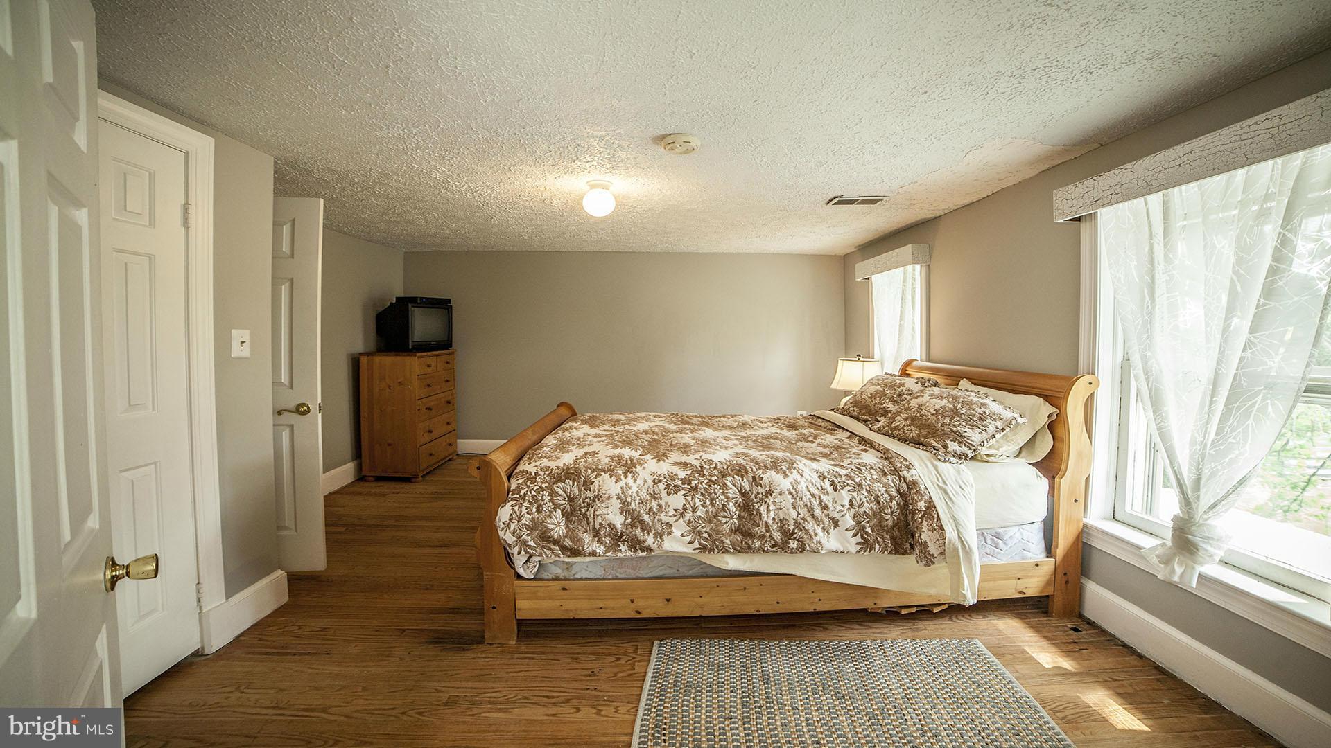 28901 Kemptown Road Mount Airy, MD 21771 - Photo 16 of 29 a bedroom with a bed and a large window