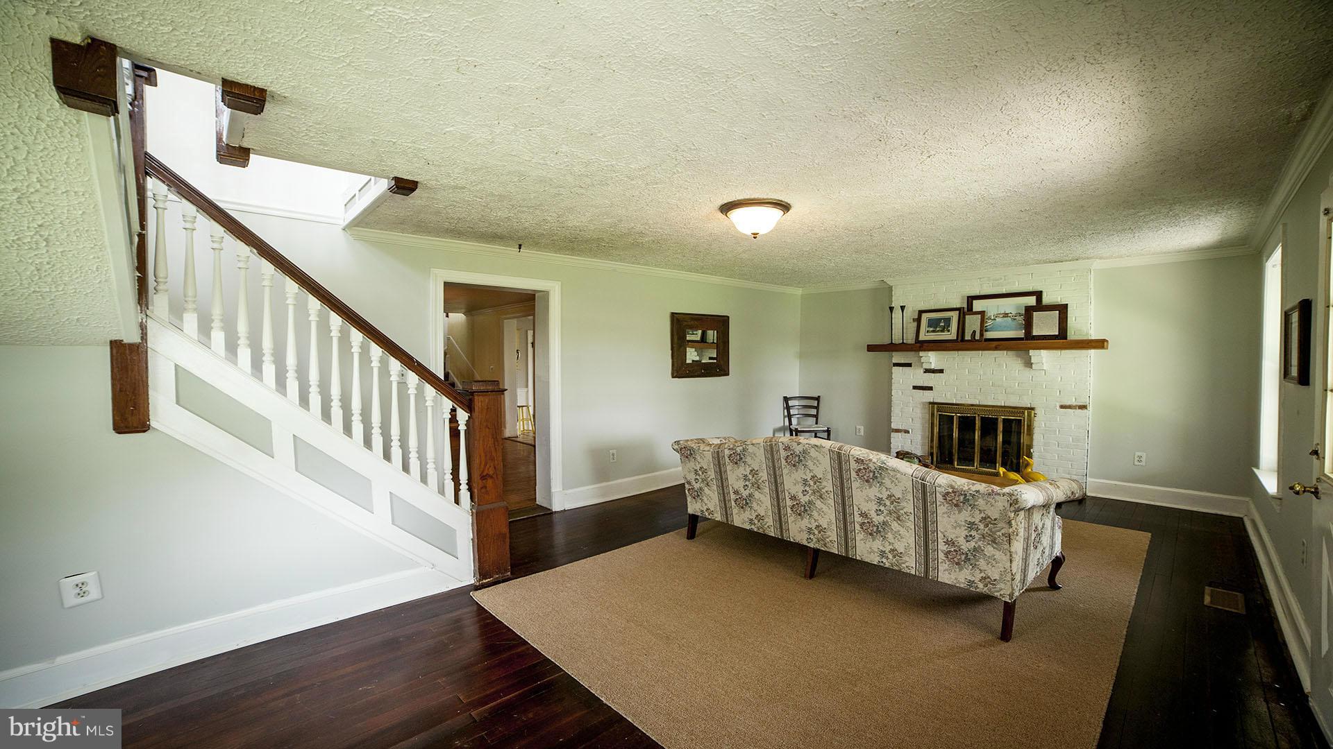 28901 Kemptown Road Mount Airy, MD 21771 - Photo 6 of 29 a living room with furniture and a fireplace