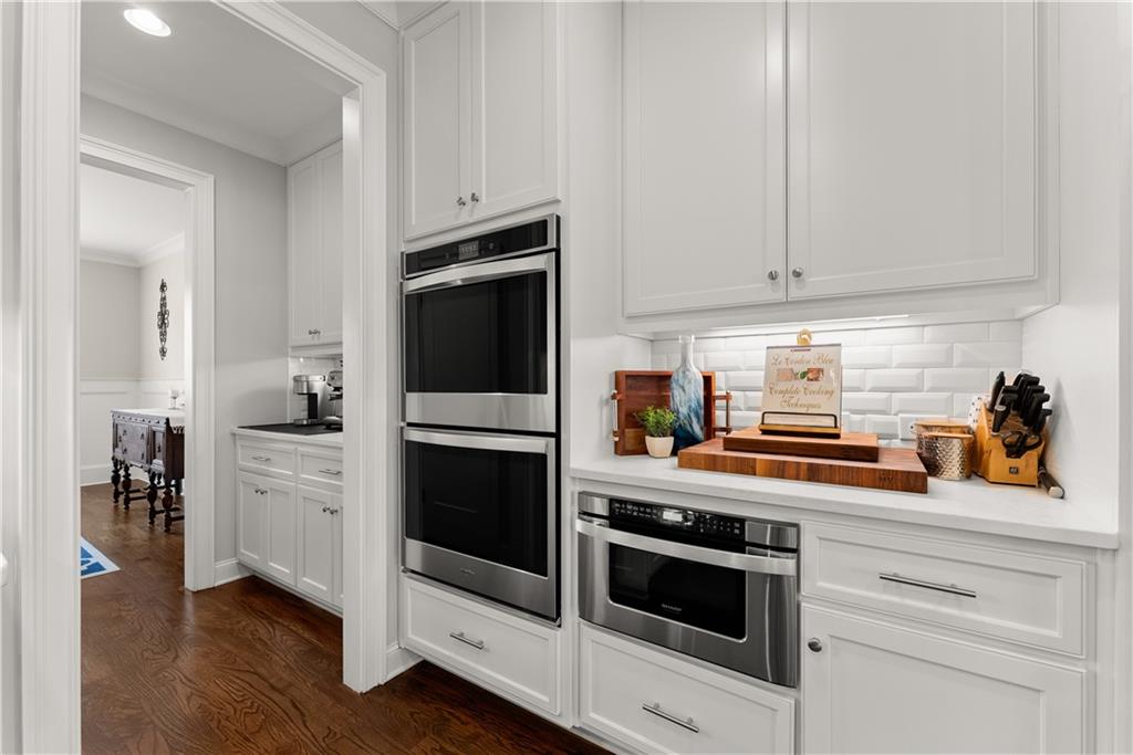 3206 Ridge Towne Place Duluth, GA 30096 - Photo 10 of 42 a kitchen with white cabinets and stainless steel appliances