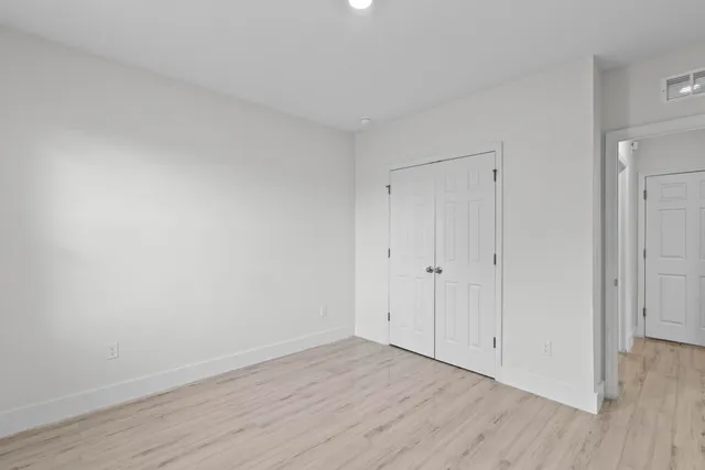 a view of an empty room and wooden floor