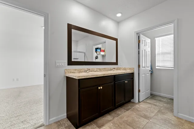 a view of cabinets with a sink and a refrigerator
