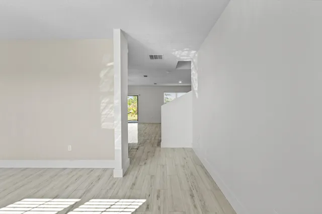 a view of hallway with wooden floor