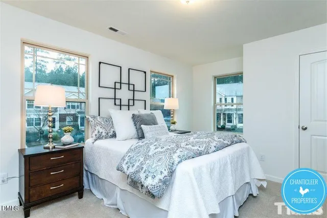 a bedroom with a large bed and a window