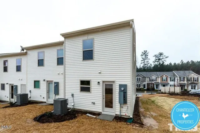 a view of a white house with swimming pool in front of it