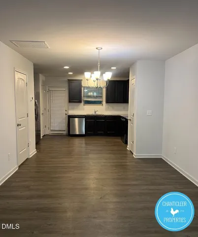 a view of a living room and kitchen with furniture