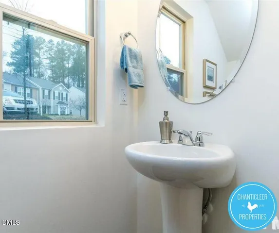 a bathroom with a sink a mirror and a window