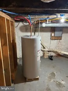 a view of a room with water heater and a refrigerator