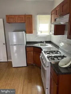 a kitchen with a stove a refrigerator and a microwave