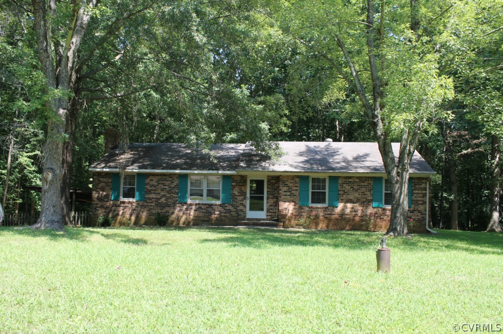 a front view of house with a garden