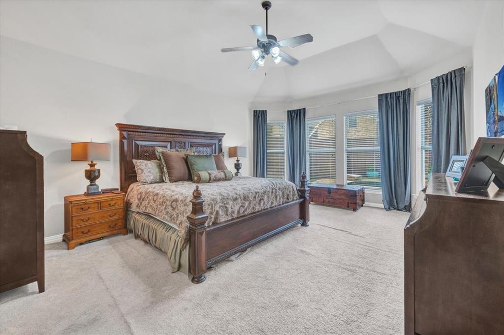 2015 Midhurst Drive Allen, TX 75013 - Photo 13 of 37 a bedroom with a large bed and a chandelier