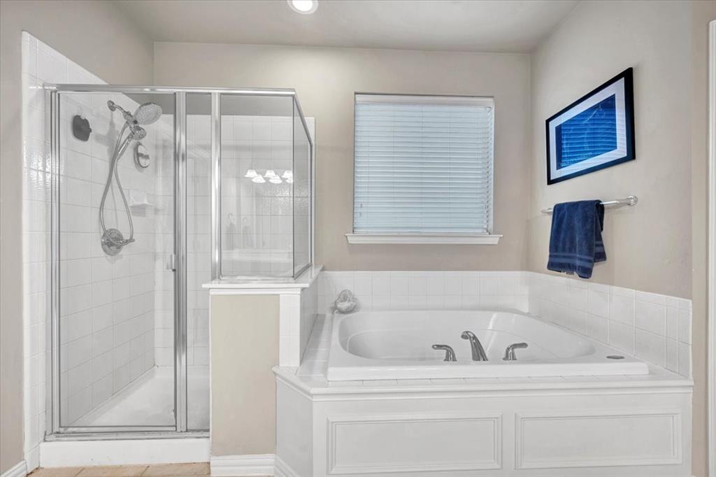 2015 Midhurst Drive Allen, TX 75013 - Photo 16 of 37 a white bath tub sitting next to a window