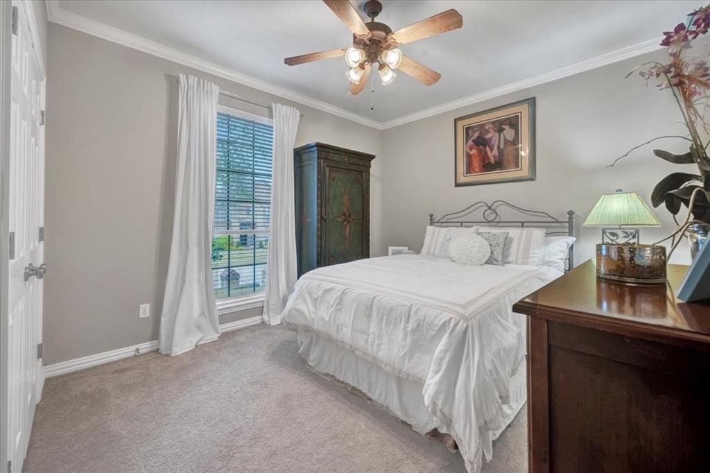 2015 Midhurst Drive Allen, TX 75013 - Photo 17 of 37 a bedroom with a bed and a chandelier