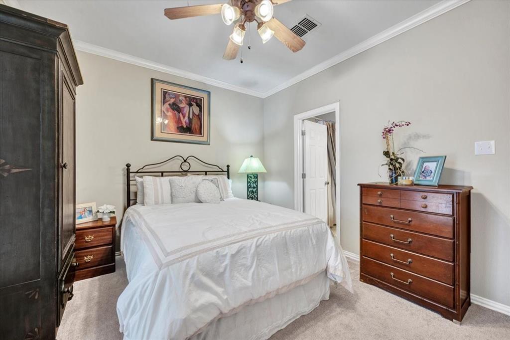 2015 Midhurst Drive Allen, TX 75013 - Photo 18 of 37 a bedroom with a bed and a chandelier
