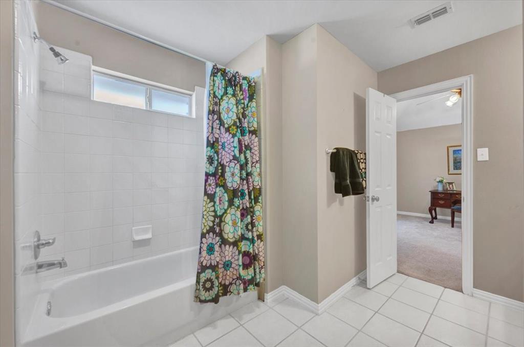 2015 Midhurst Drive Allen, TX 75013 - Photo 28 of 37 a bathroom with a shower and a tub