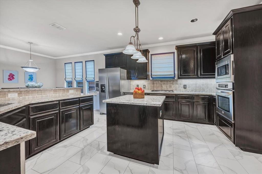 2015 Midhurst Drive Allen, TX 75013 - Photo 6 of 37 a kitchen with a stove sink and refrigerator