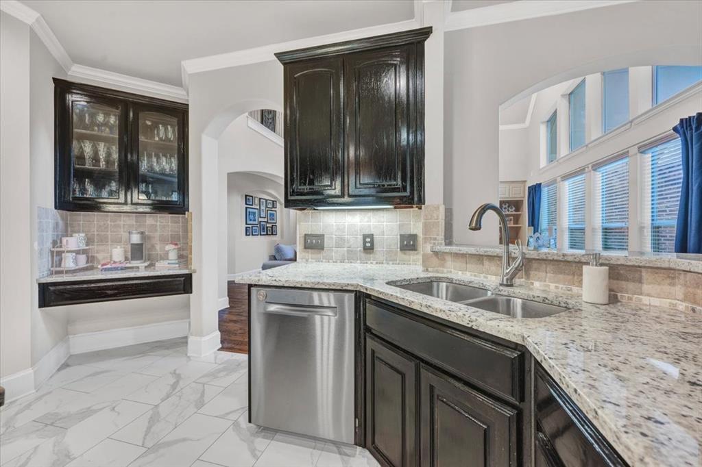 2015 Midhurst Drive Allen, TX 75013 - Photo 7 of 37 a kitchen with granite countertop a sink and a stove