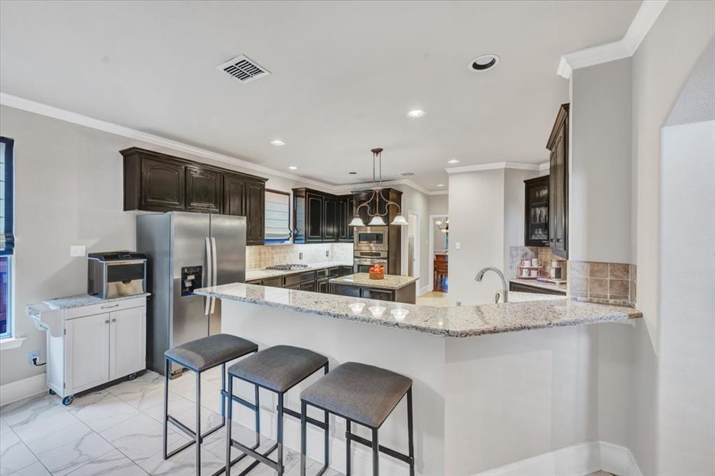2015 Midhurst Drive Allen, TX 75013 - Photo 8 of 37 a kitchen with kitchen island a sink stove and refrigerator