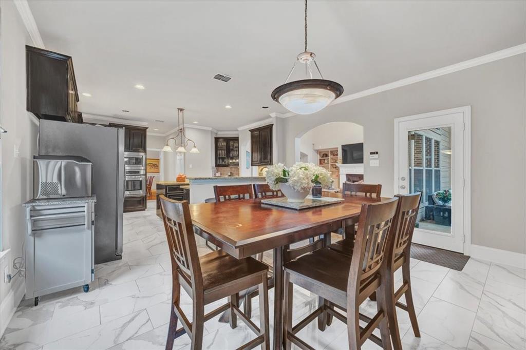 2015 Midhurst Drive Allen, TX 75013 - Photo 10 of 37 a dining room with stainless steel appliances kitchen island granite countertop a dining table and chairs