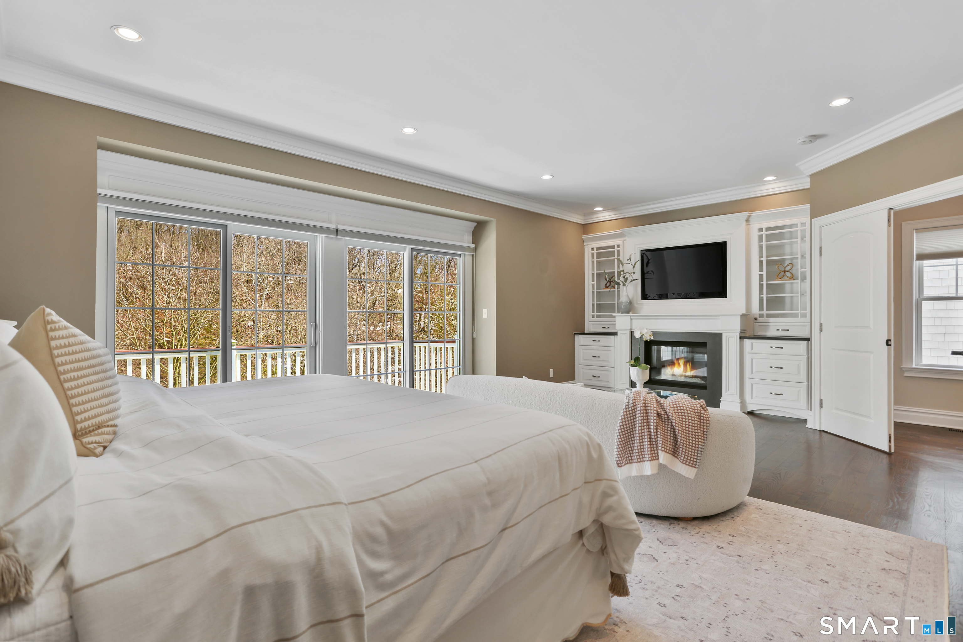 2 Trout Creek Road, Unit 2 Shelton, CT 06484 - Photo 19 of 38 Spacious primary bedroom with hardwood floors, gas fireplace, custom built-ins, and sitting area.