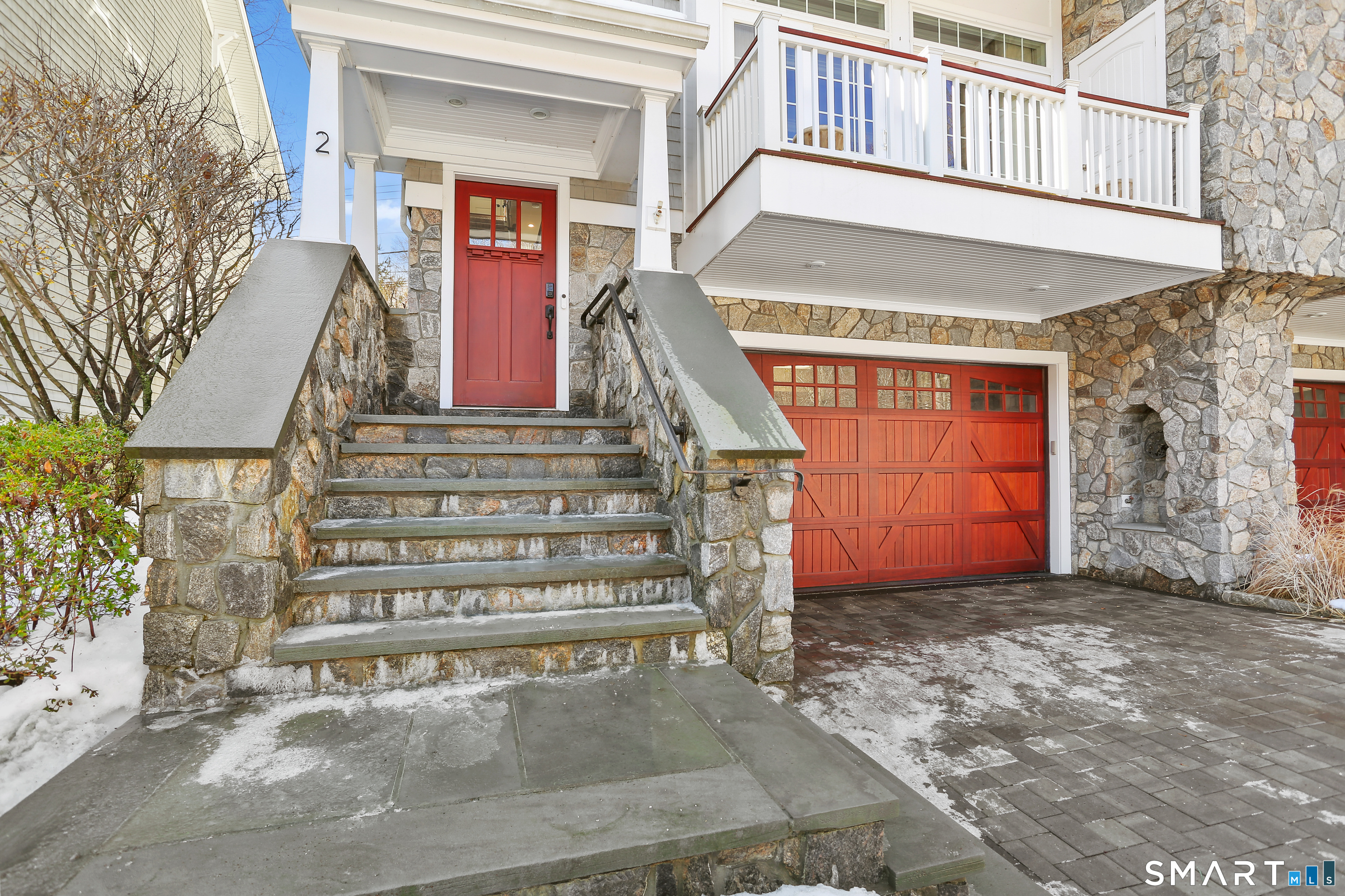2 Trout Creek Road, Unit 2 Shelton, CT 06484 - Photo 2 of 38 Stone entry steps and mahogany double garage doors highlight the home's distinctive architectural character, complemented by a private elevator connecting all four levels.