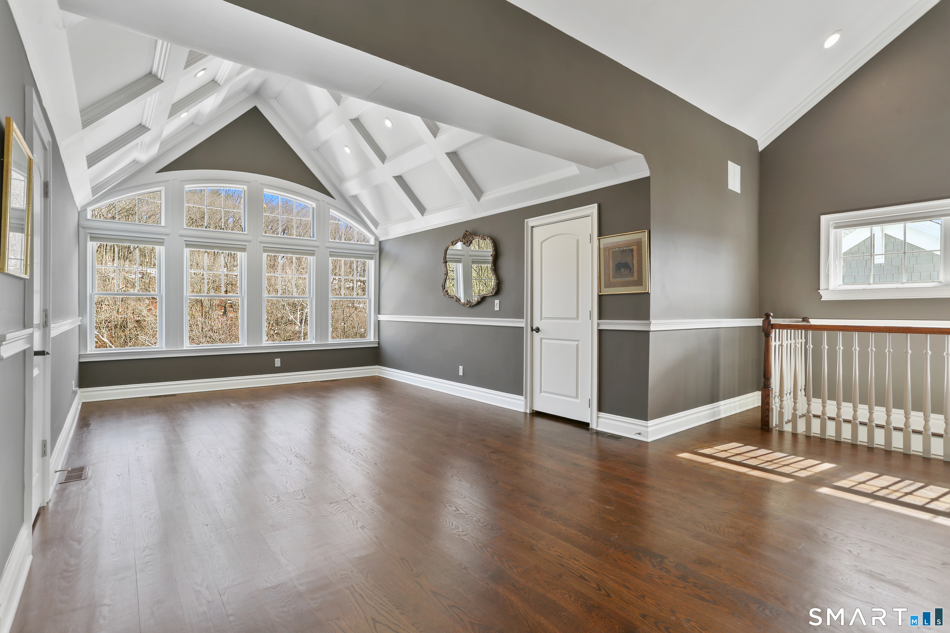 2 Trout Creek Road, Unit 2 Shelton, CT 06484 - Photo 27 of 38 Dramatic open-concept level with vaulted and coffered ceilings and striking windows. With the full bath located just beside it, this space is a great third bedroom and offers a spacious private retreat.