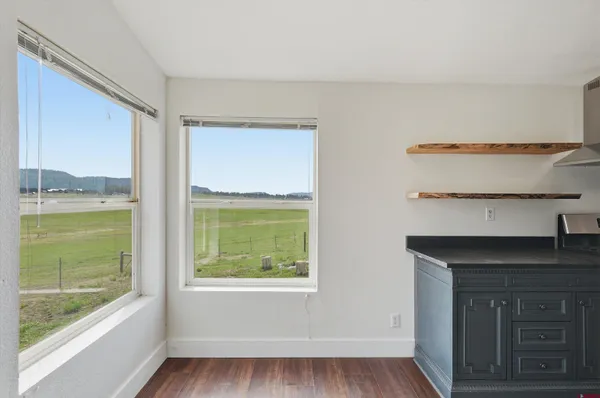 a hallway with a large window and a fireplace