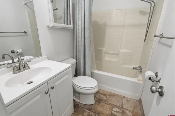 a bathroom with a sink toilet and shower